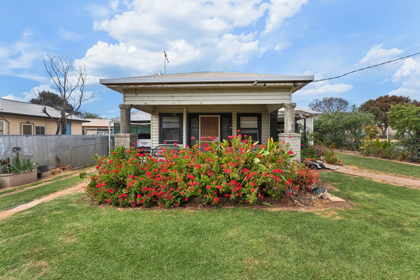 Front porch behind flowering garden beds