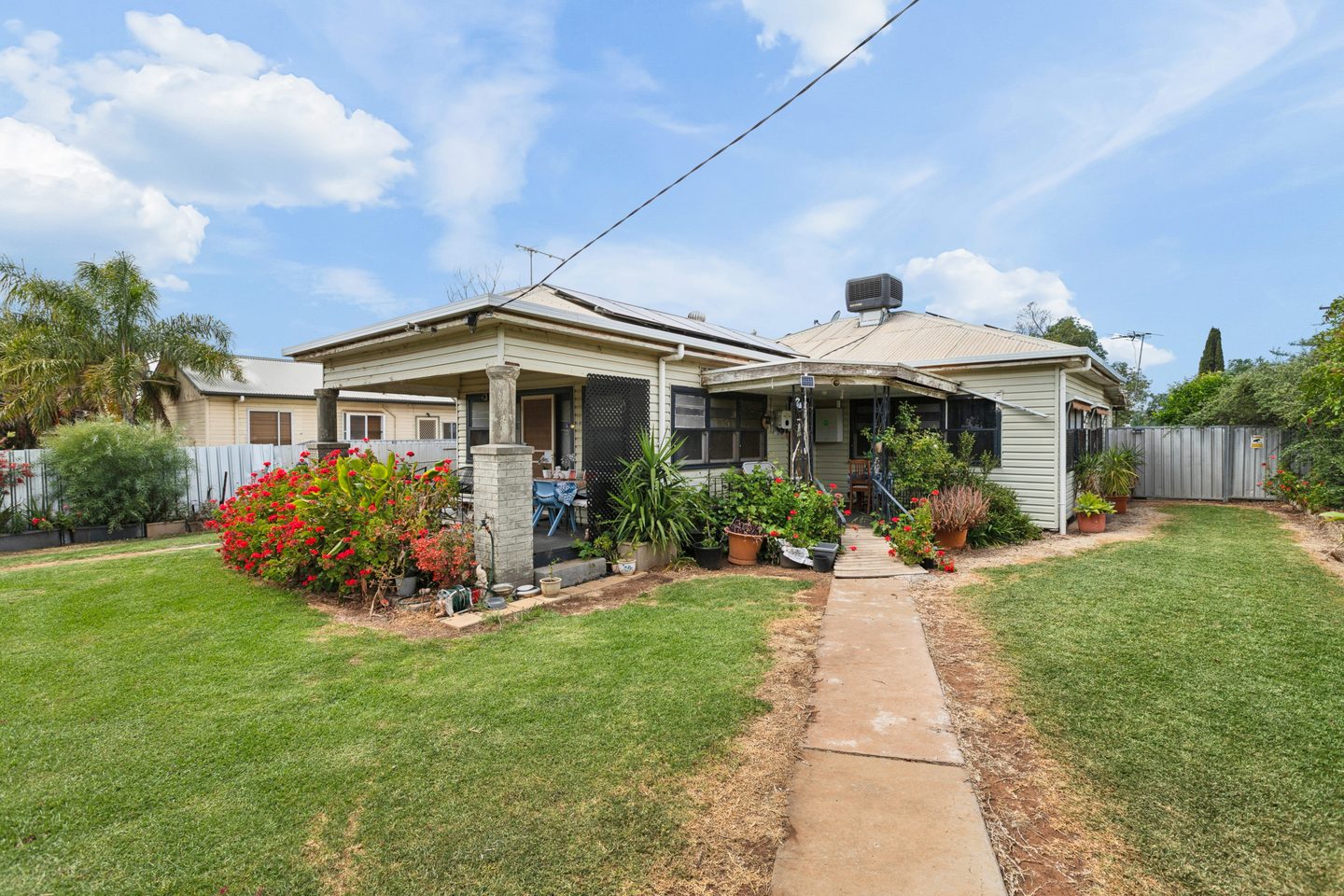 Front garden, entrance path and home with rooftop solar panels