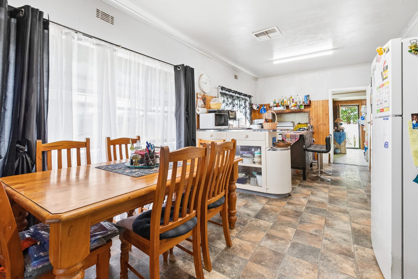 Connected kitchen and dining area with a wide window