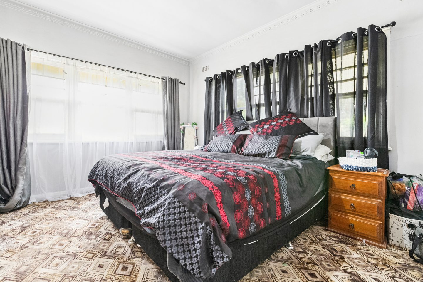 Main bedroom with windows on adjoining walls