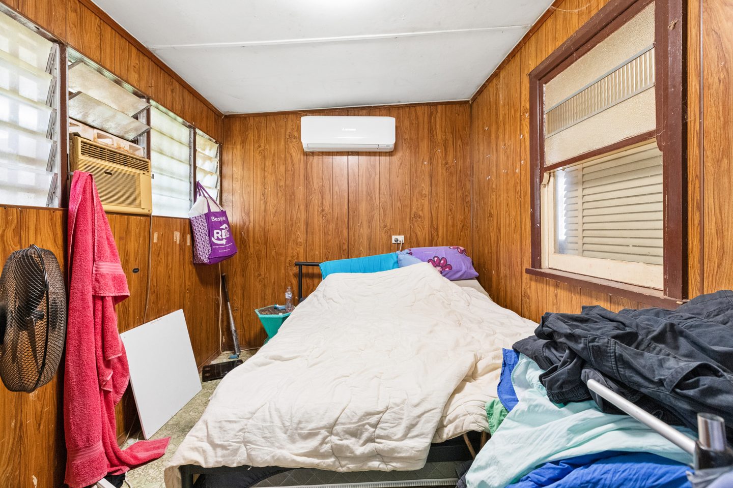 Rear bedroom with wall panelling and split-system air conditioning