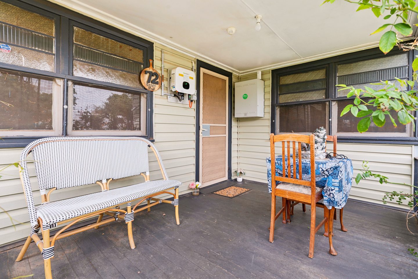 Sheltered porch with textured-glass windows and dark trim