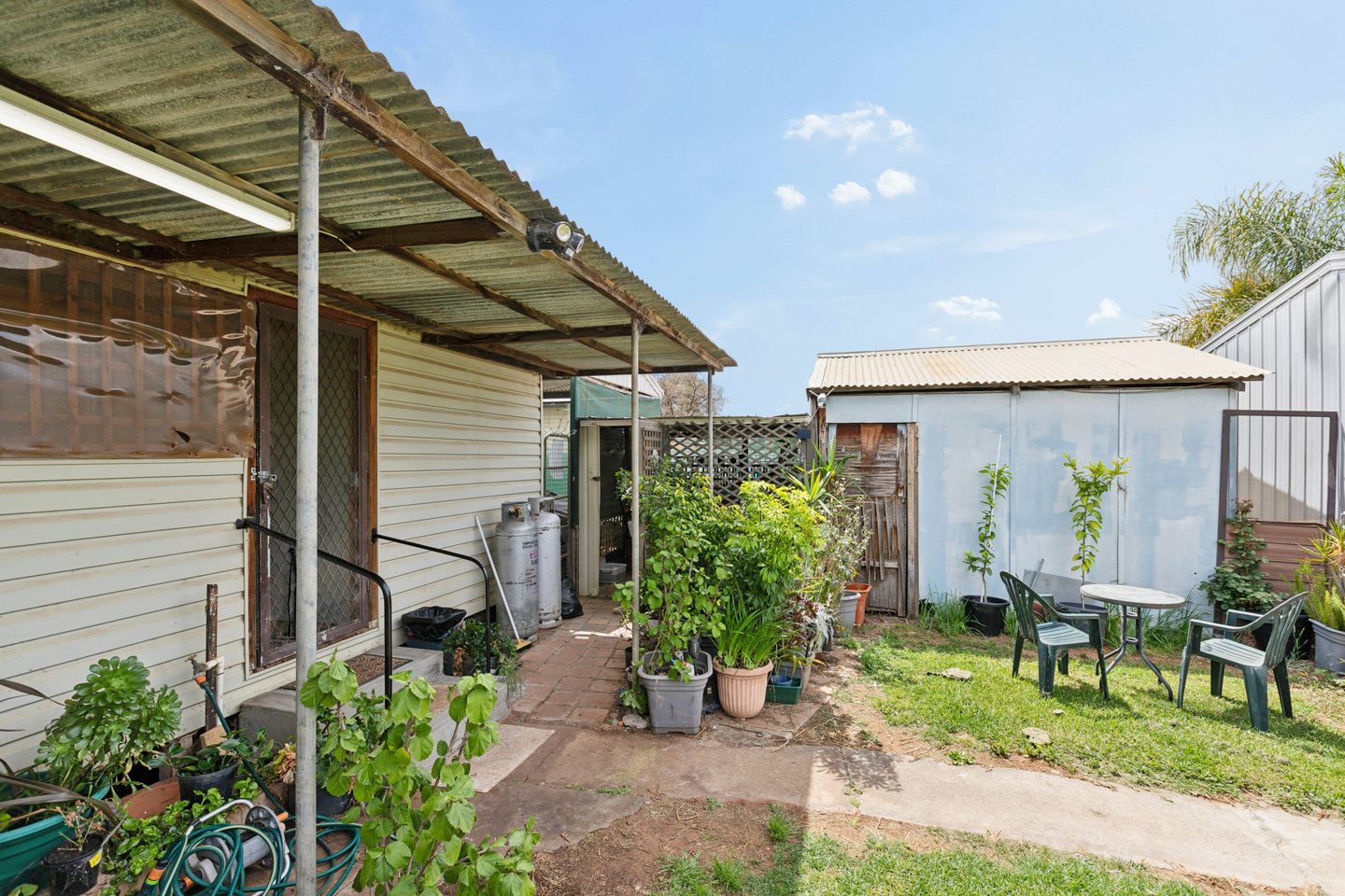 Path beside the rear patio leading towards the shed